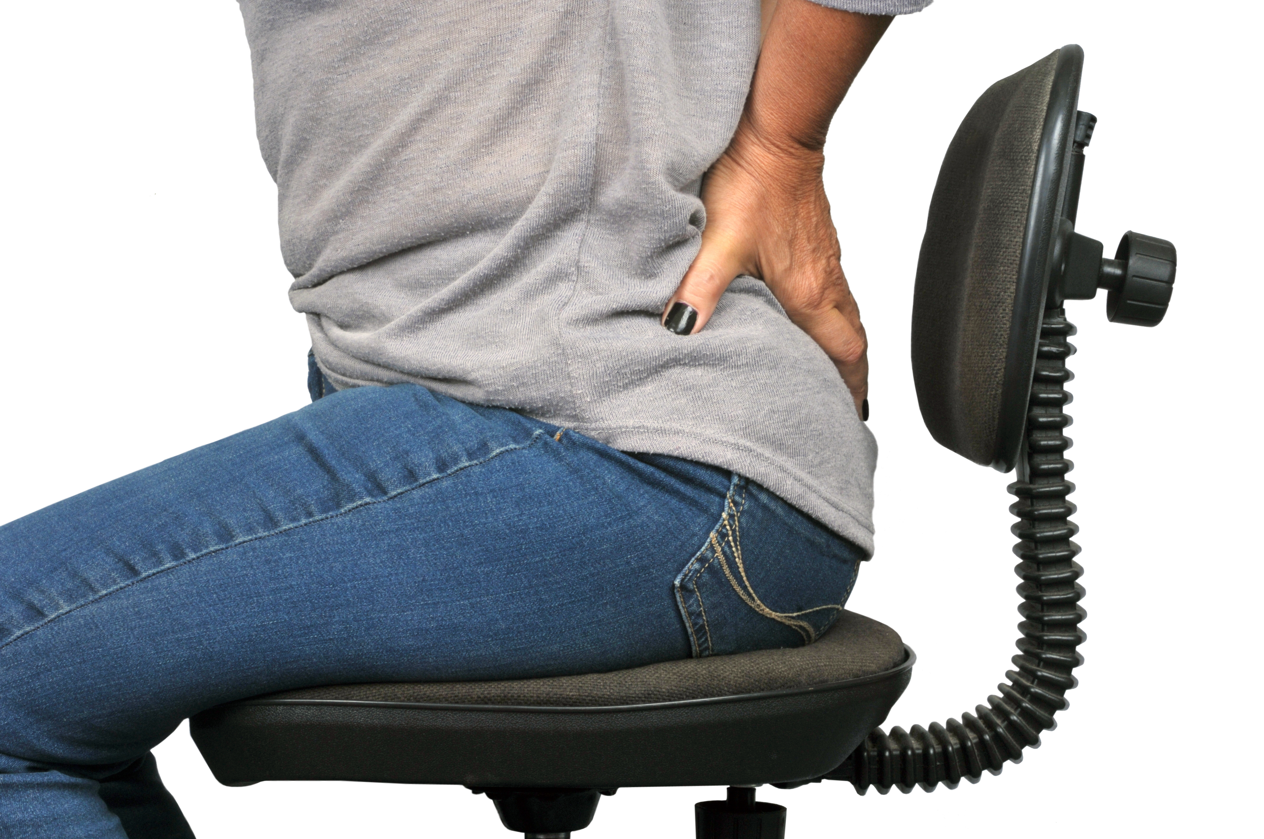 person sitting in a chair holding their back because they need to see Sciatica Chiropractors Athens GA, sciatic nerve treatment