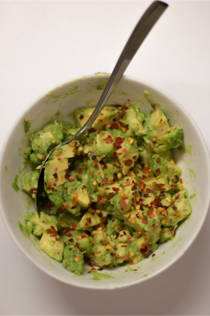 bowl of avacodo seasoned with red pepper flakes for Nutrition Consulting & Lifestyle Coaching
