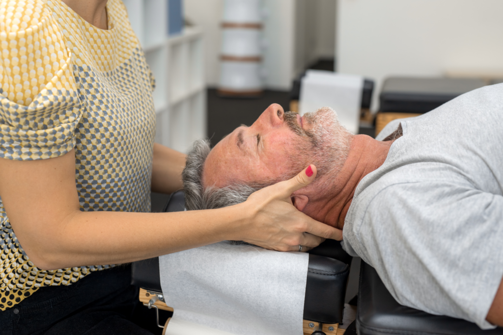 man getting treated for migraines with chiropractic care